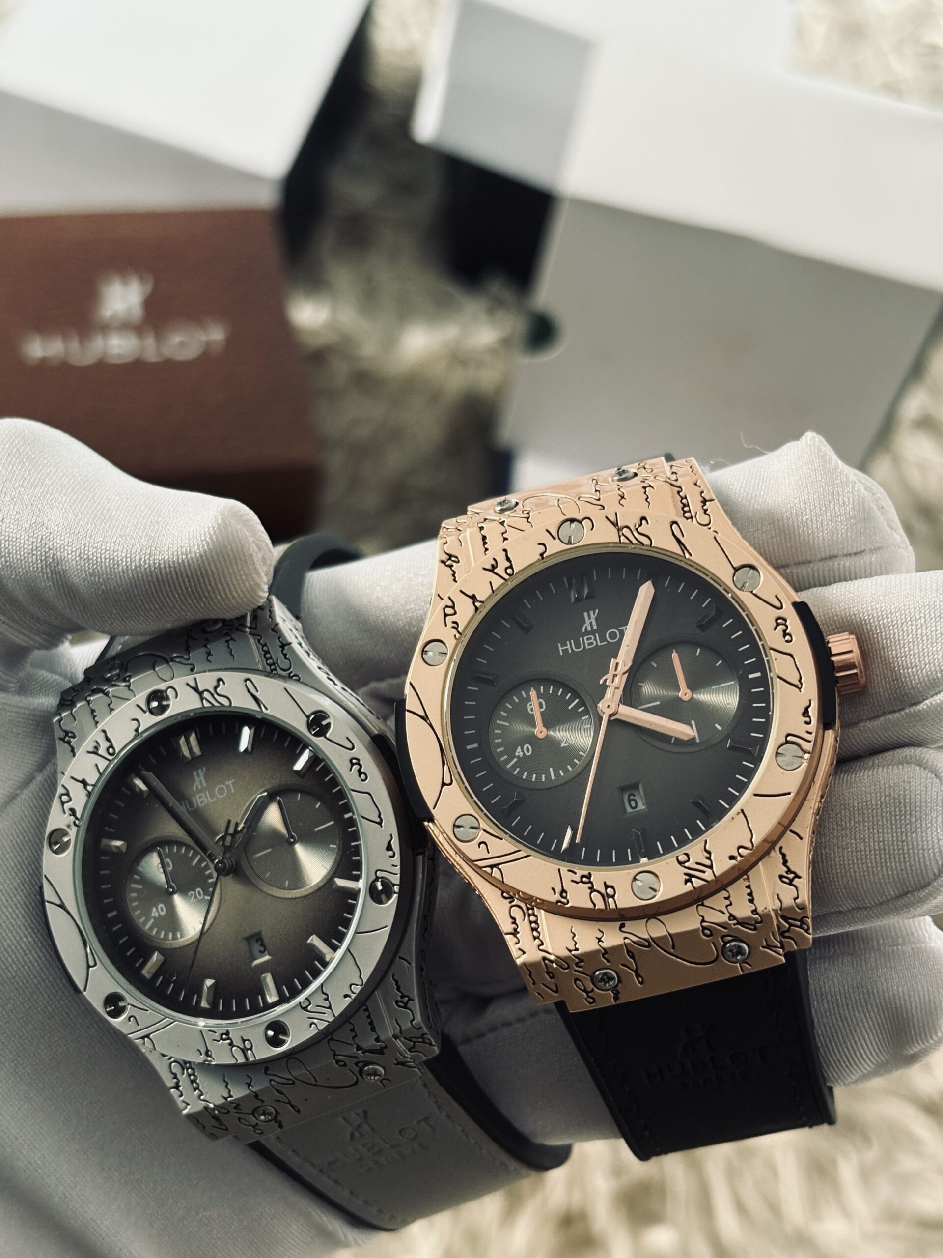 D. 1 BLACK WITH GOLD AND 1 GREY HUBLOT (42,000 XAF)