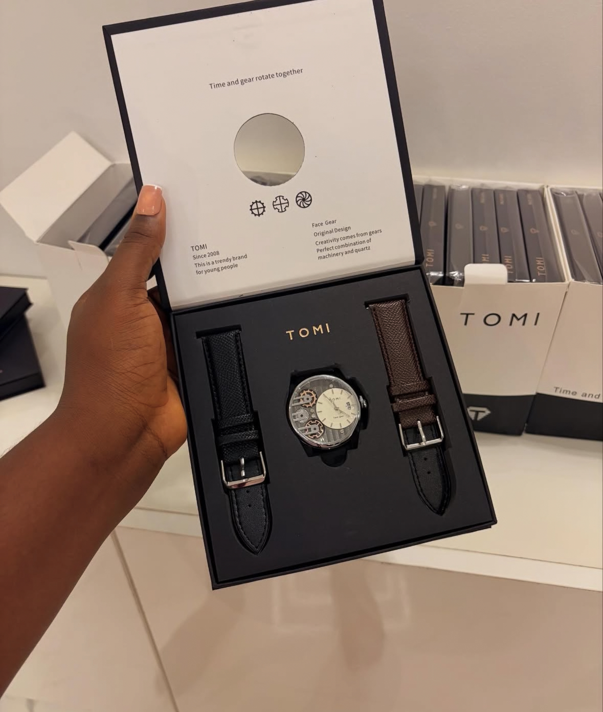 1 BLACK AND BROWN TOMI FACEGEAR TIMEPEICE (6,500 KES)